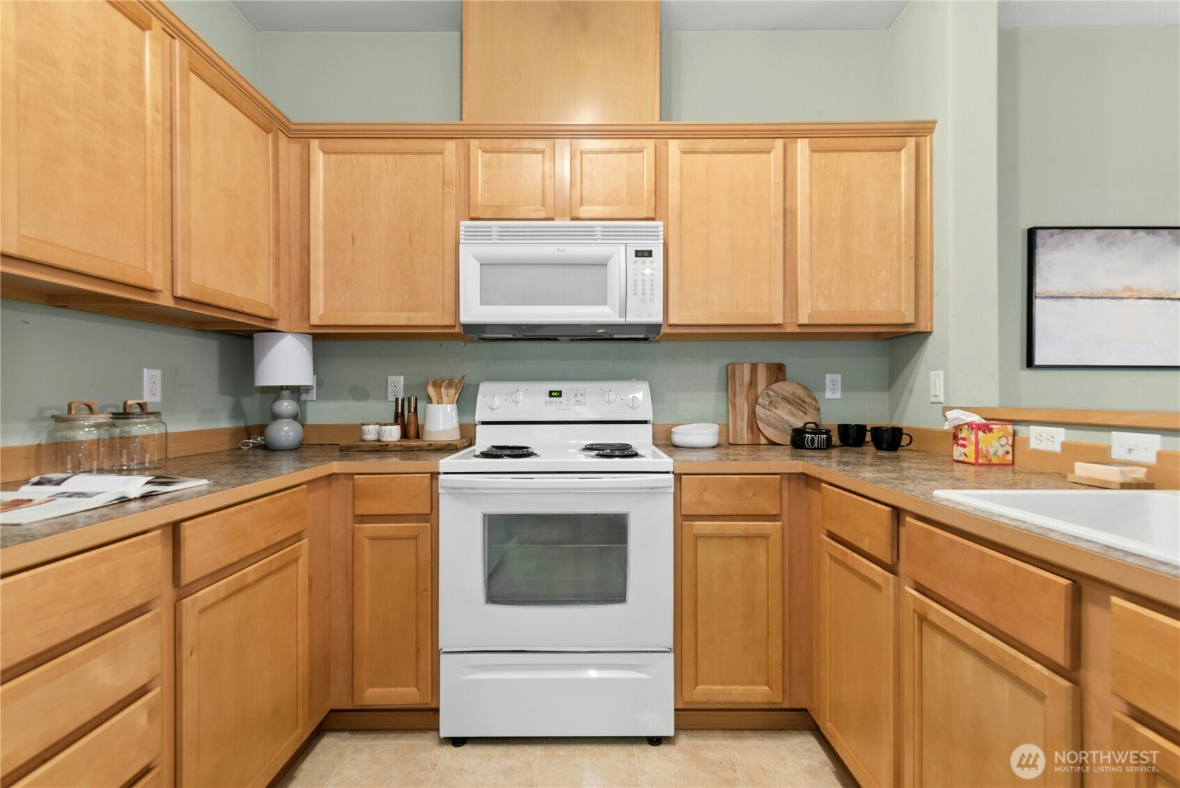 14915 38th Drive Southeast, Unit II1033 Bothell, WA 98012 - Photo 7 of 25 a kitchen with cabinets appliances a sink and a window