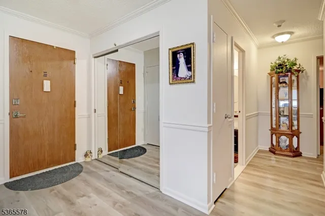 a view of a hallway with wooden floor and entryway