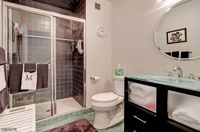 a bathroom with a toilet a sink and glass door