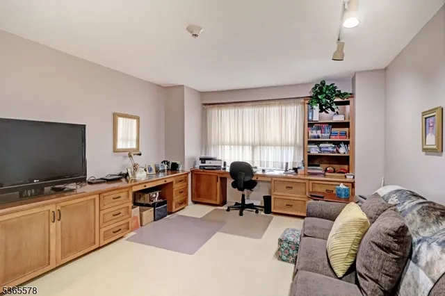 a room with furniture a piano and a flat screen tv