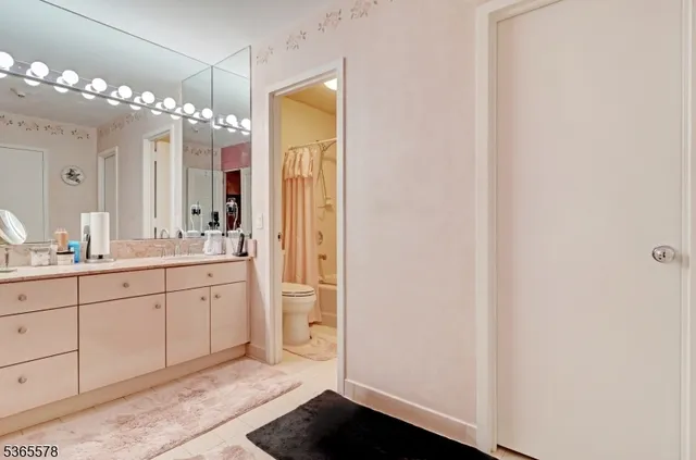 a spacious bathroom with a double vanity sink and a mirror