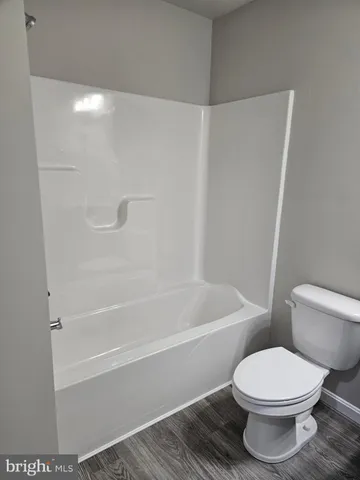 a bathroom with a toilet and a bath tub