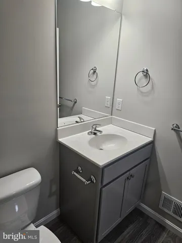 a bathroom with a sink toilet and a mirror