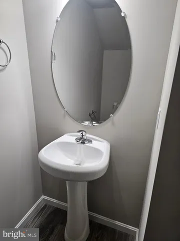 a bathroom with a sink toilet and mirror