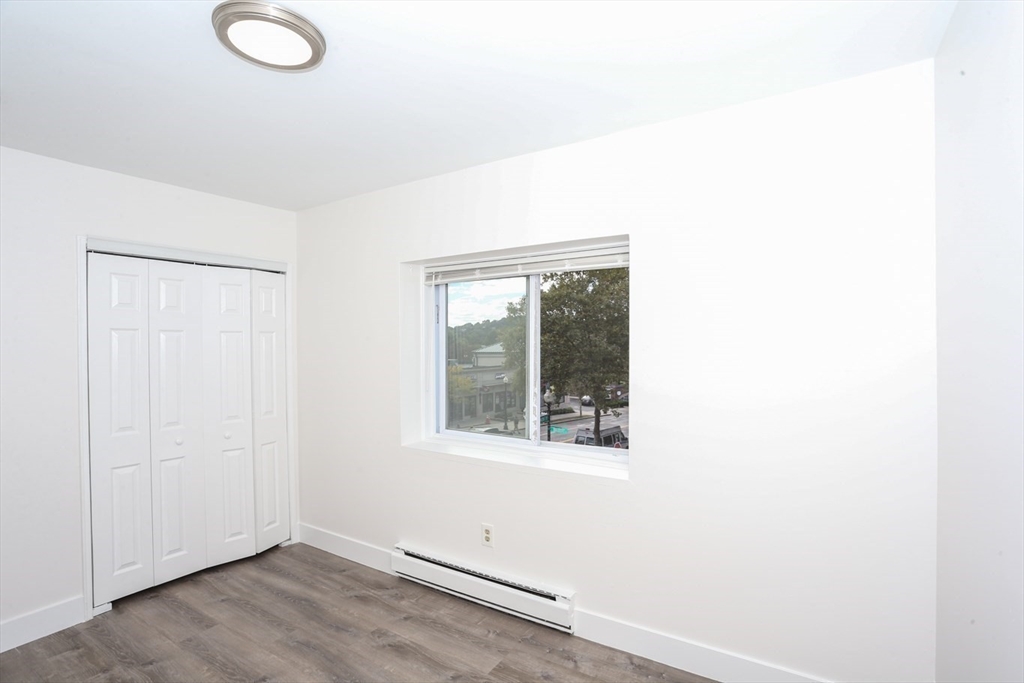 461 Washington Street, Unit 301 Boston, MA 02135 - Photo 9 of 13 an empty room with a window