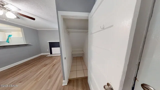 a view of empty room with wooden floor