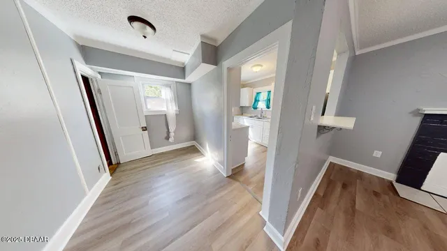 a view of hallway with wooden floor and stairs
