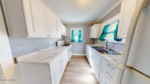 a kitchen with a sink stove and cabinets