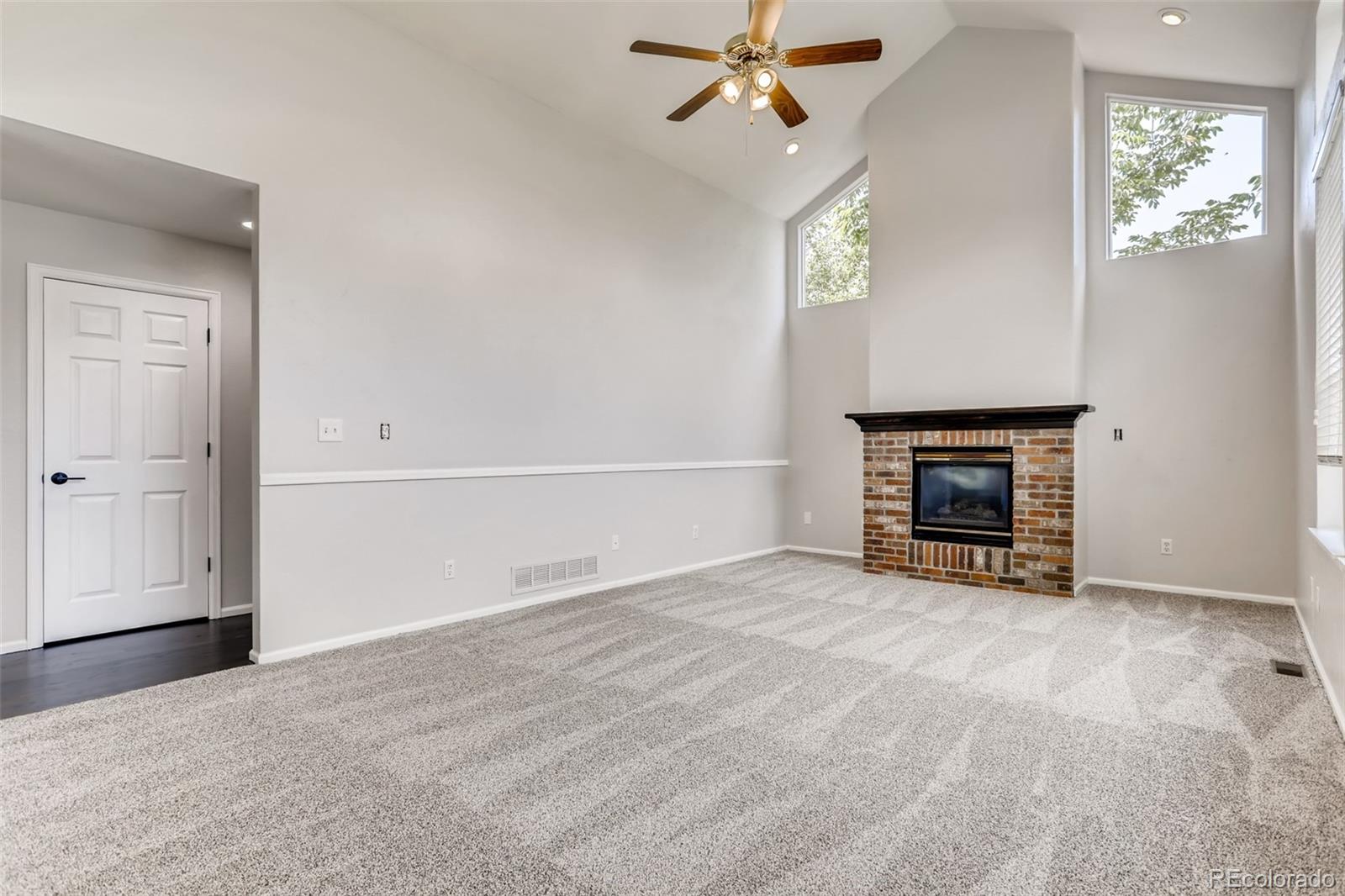 1639 Spring Water Lane Highlands Ranch, CO 80129 - Photo 18 of 39 a view of an empty room with a fireplace and a window