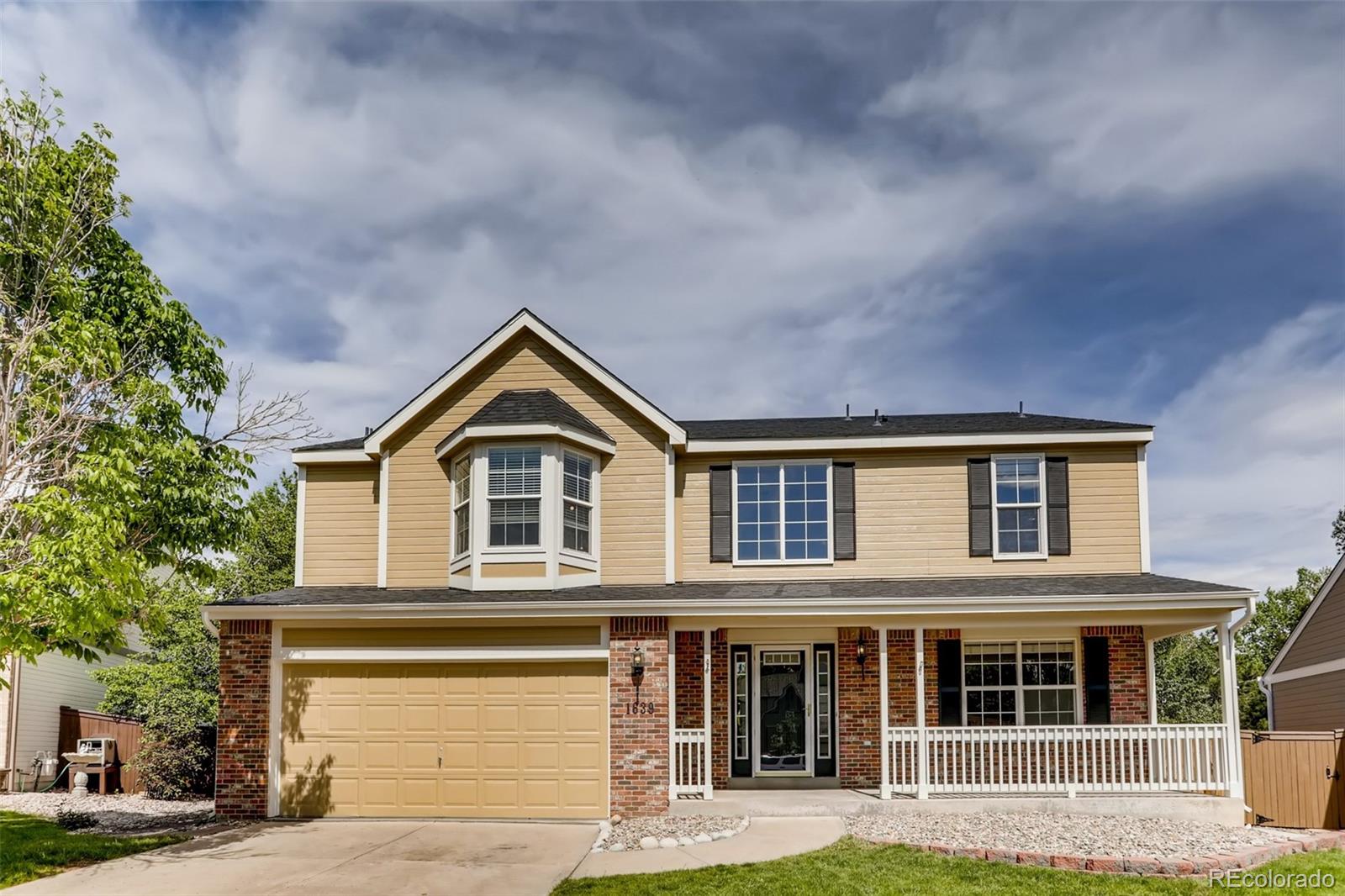 1639 Spring Water Lane Highlands Ranch, CO 80129 - Photo 2 of 39 front view of house with a yard