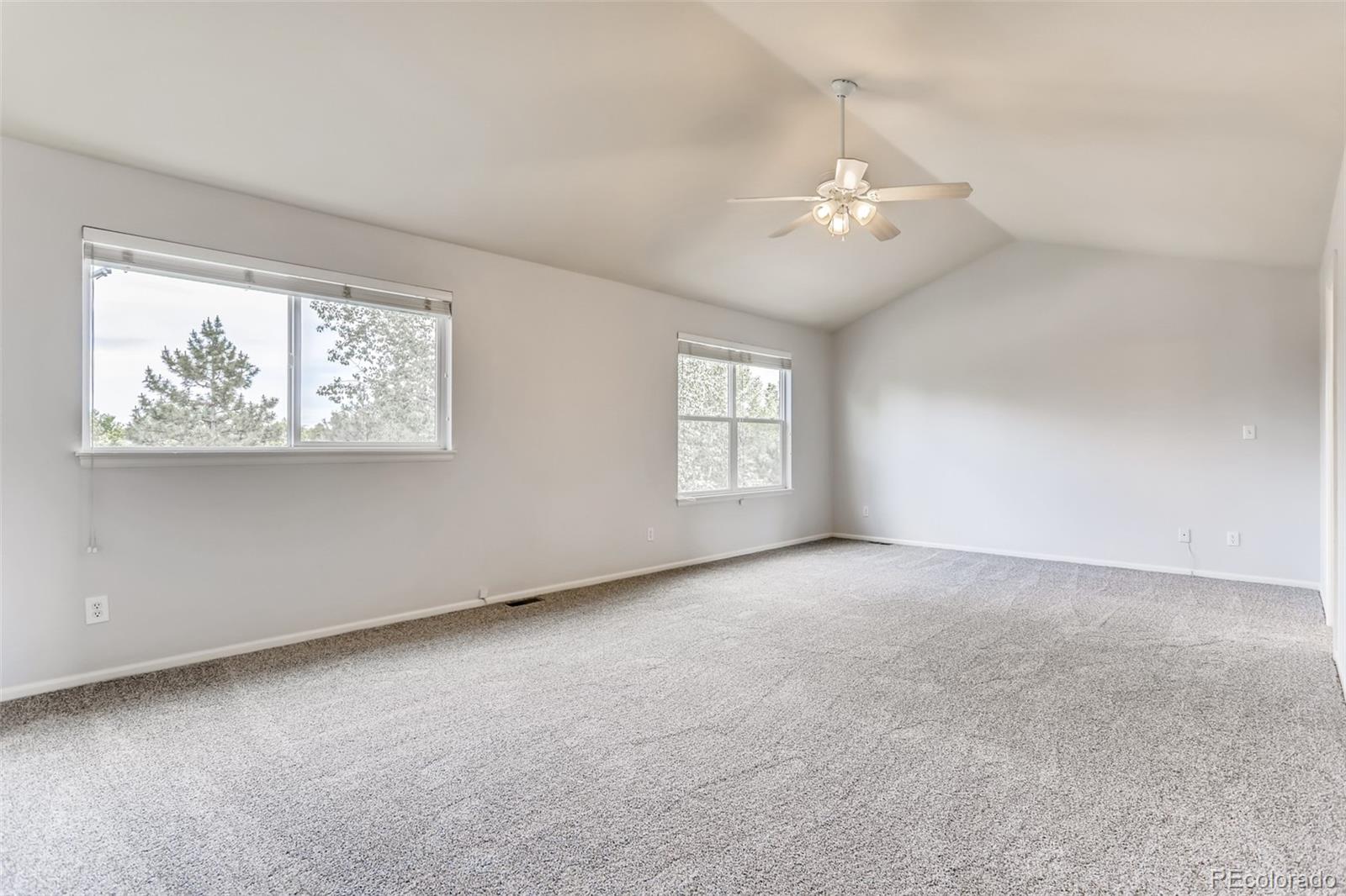1639 Spring Water Lane Highlands Ranch, CO 80129 - Photo 23 of 39 an empty room with windows and ceiling fan