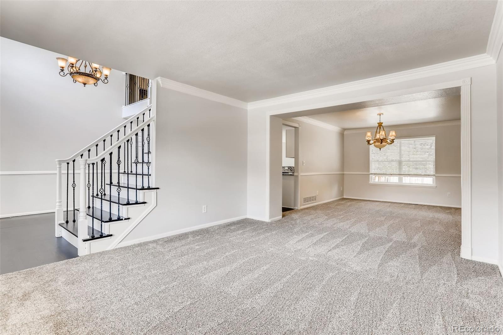 1639 Spring Water Lane Highlands Ranch, CO 80129 - Photo 6 of 39 a view of an empty room with wooden floor and stairs
