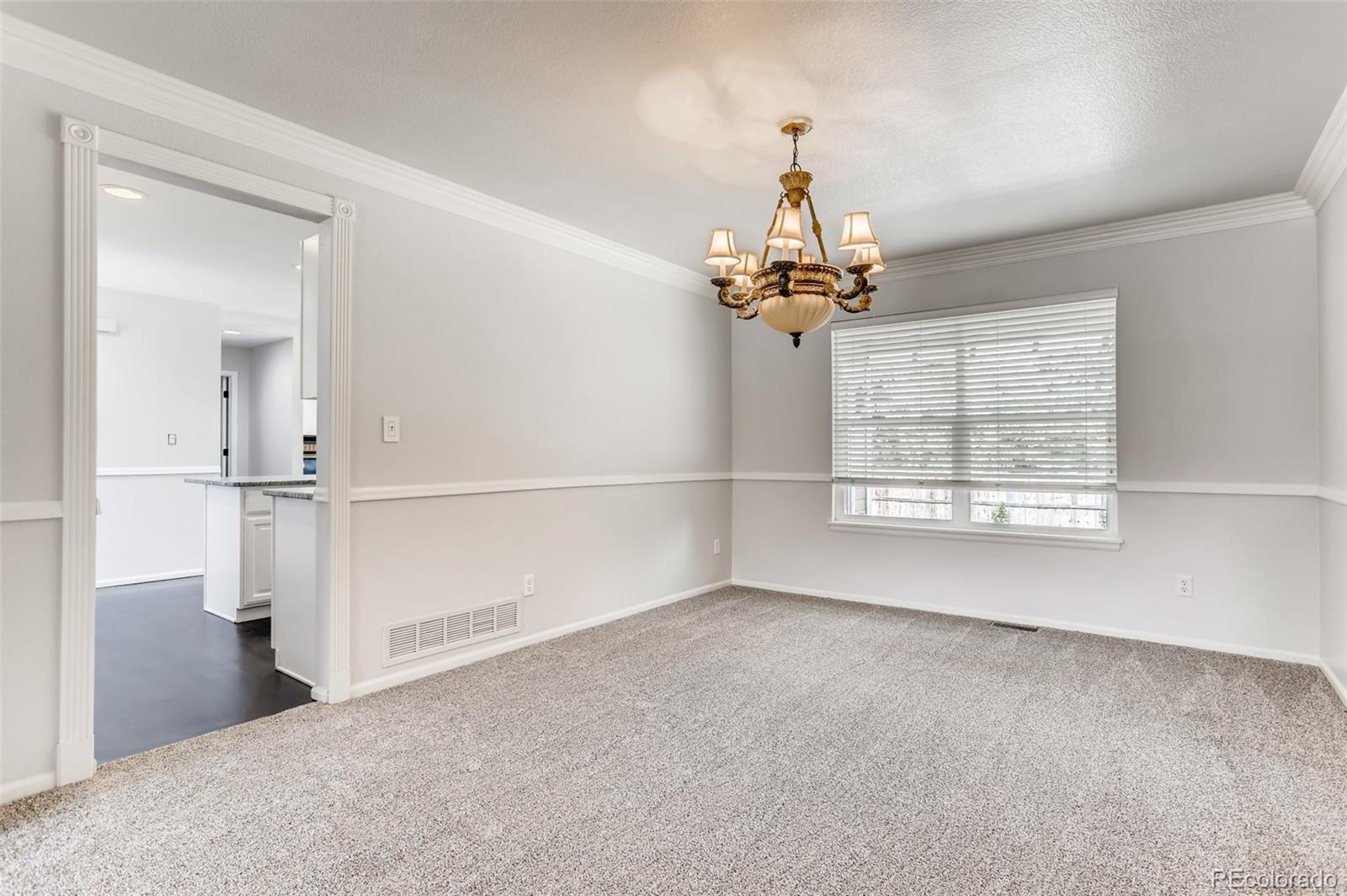 1639 Spring Water Lane Highlands Ranch, CO 80129 - Photo 9 of 39 wooden floor in an empty room with a window