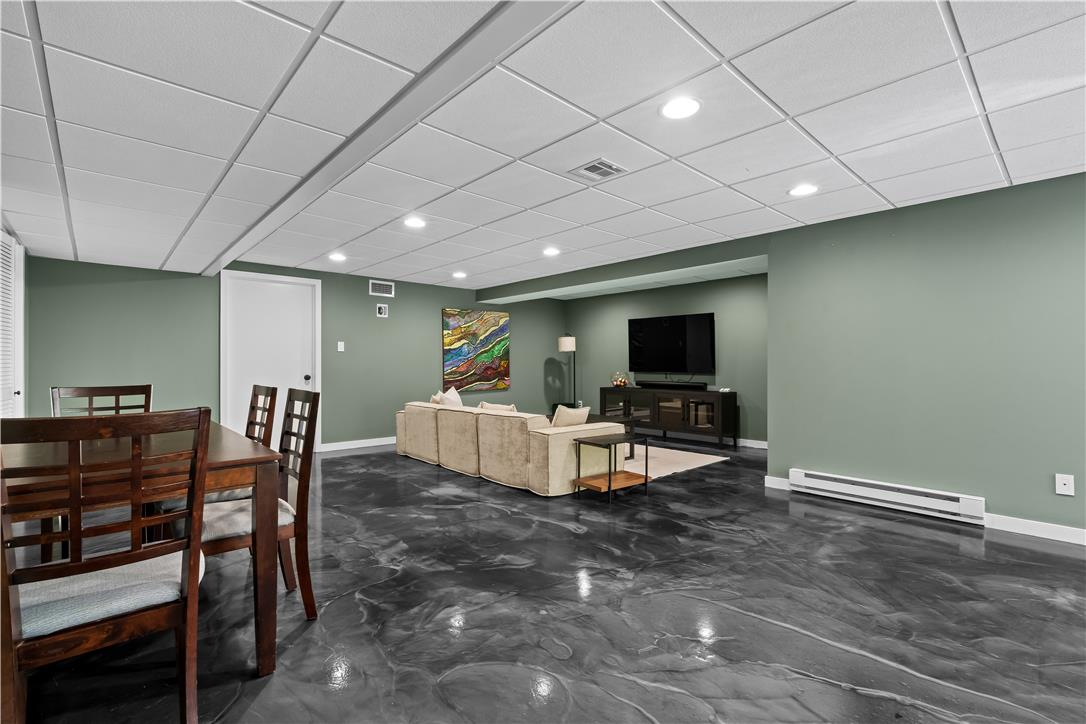 1506 Pleasant View Road Coopersburg, PA 18036 - Photo 66 of 97 A versatile open-plan basement provides both dining and living spaces, illuminated by recessed lighting.