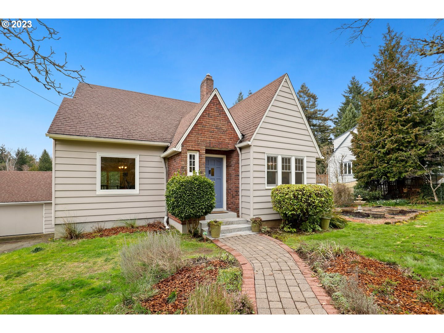 2830 Southwest Taylors Ferry Road Portland, OR 97219 - Photo 1 of 40 a front view of a house with garden