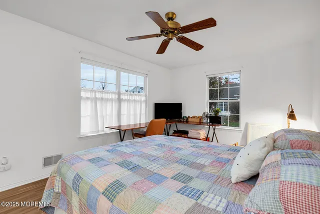 a bedroom with a bed and a large window