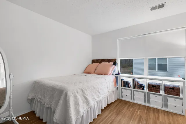 a bed room with a bed and a wooden floor