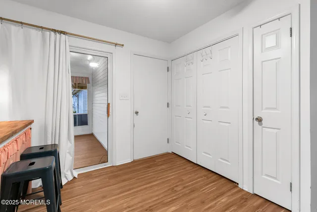 a view of a hallway with wooden floor