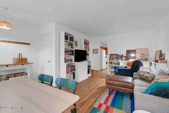 a bedroom with furniture and a flat screen tv