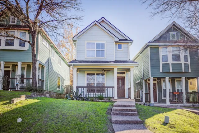 a front view of brick house with a yard