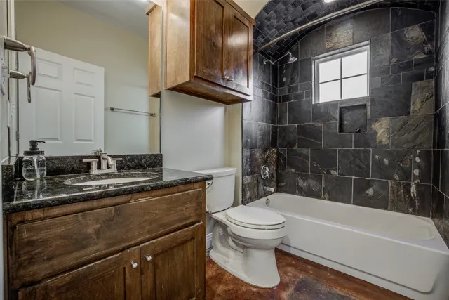 a bathroom with a sink a toilet and bathtub