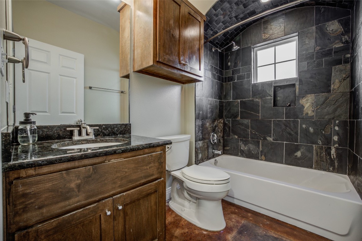 4109 East 12th Street, Unit 2 Austin, TX 78721 - Photo 16 of 39 a bathroom with a sink a toilet and bathtub