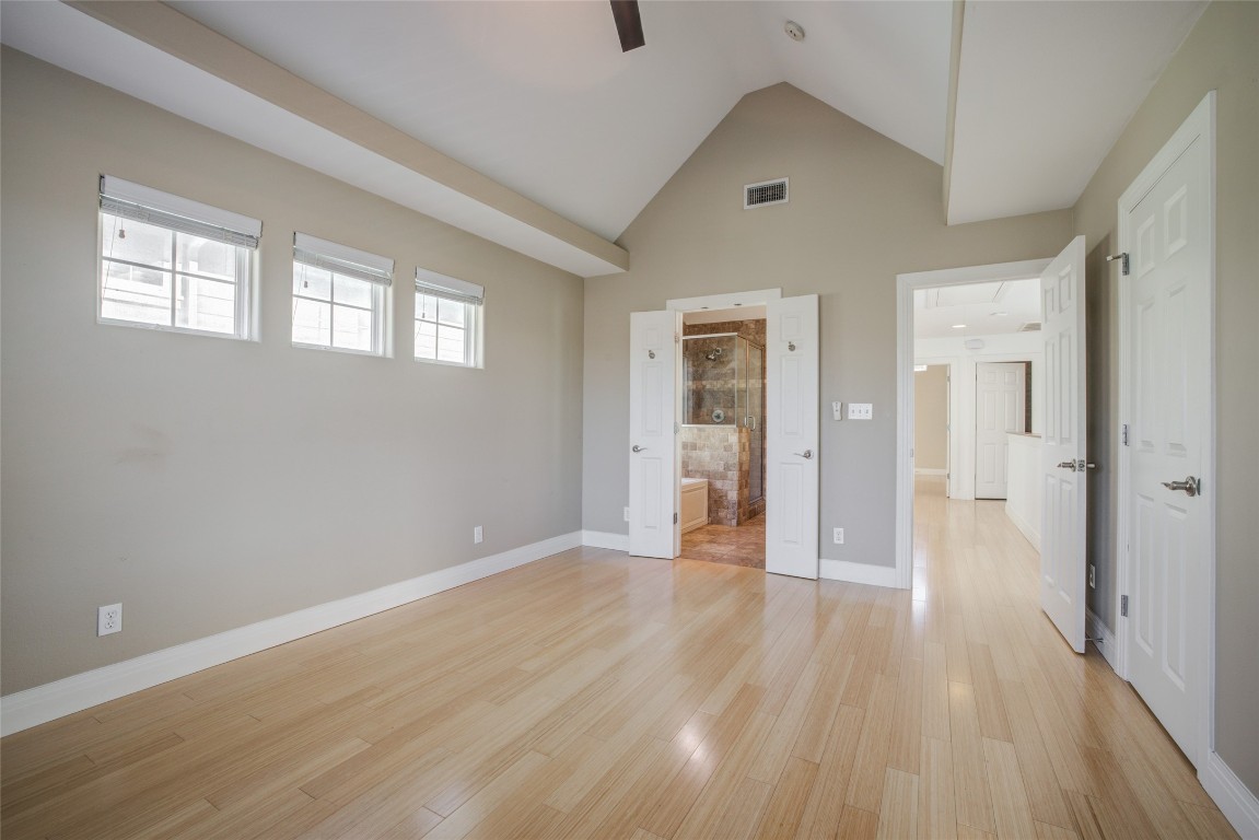 4109 East 12th Street, Unit 2 Austin, TX 78721 - Photo 20 of 39 an empty room with wooden floor and windows