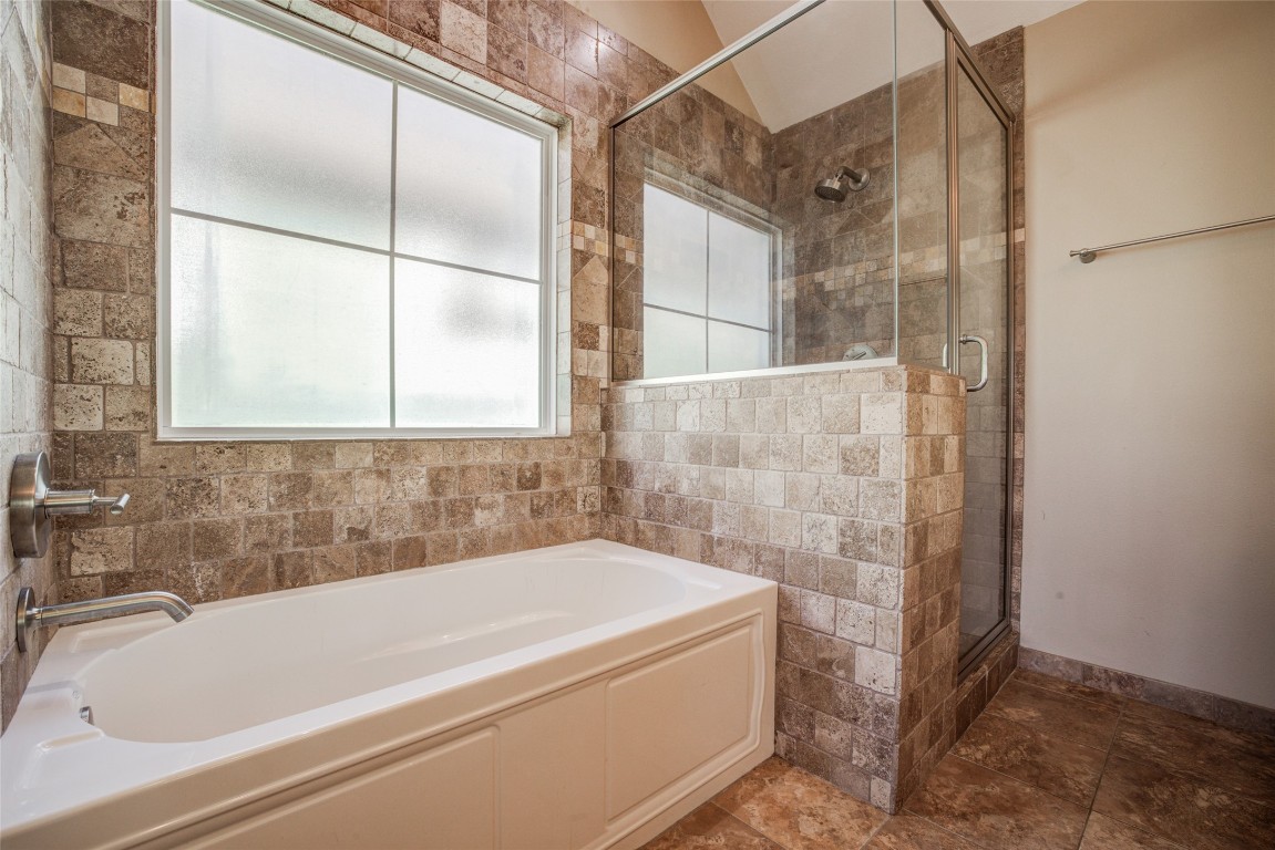 4109 East 12th Street, Unit 2 Austin, TX 78721 - Photo 23 of 39 a bath tub sitting next to a shower