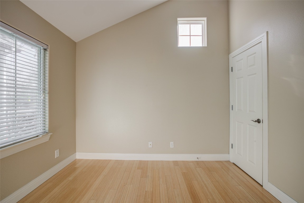 4109 East 12th Street, Unit 2 Austin, TX 78721 - Photo 31 of 39 an empty room with wooden floor and windows