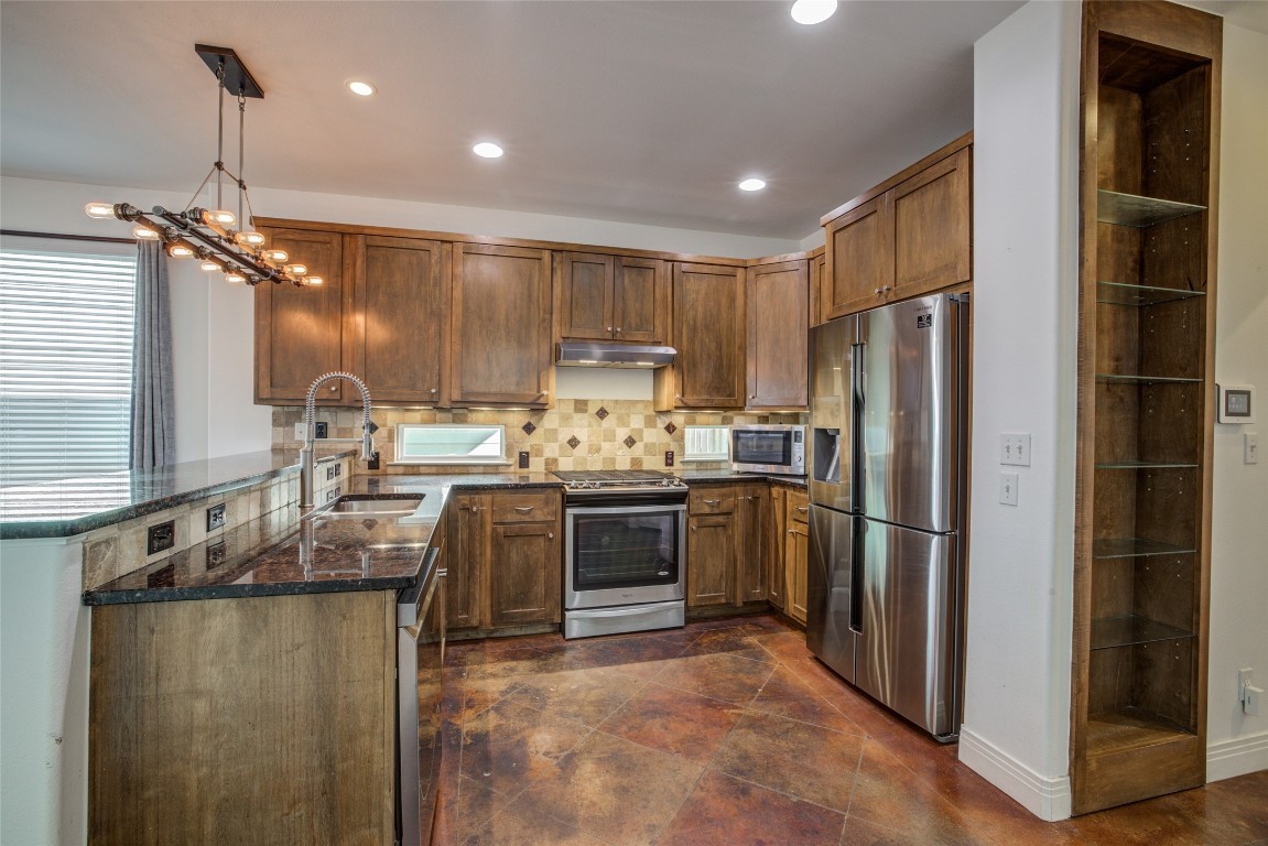 4109 East 12th Street, Unit 2 Austin, TX 78721 - Photo 10 of 39 a kitchen with kitchen island a counter top space stainless steel appliances and cabinets