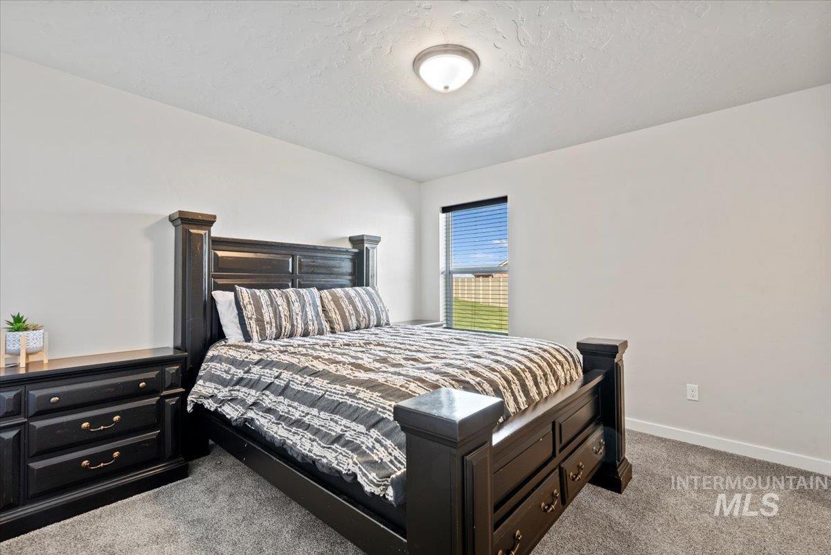 1211 Mahogany Street Parma, ID 83660 - Photo 17 of 30 Bedroom with carpet and a textured ceiling