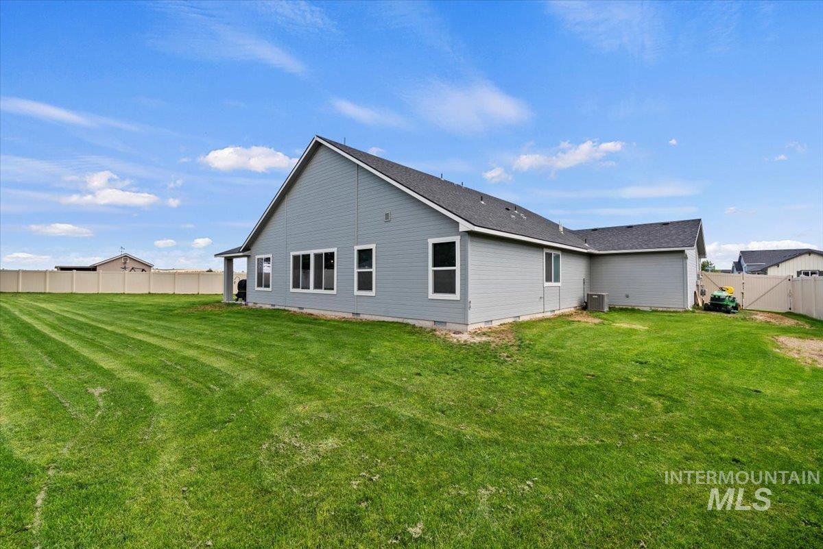 1211 Mahogany Street Parma, ID 83660 - Photo 29 of 30 Rear view of house featuring a fenced backyard and crawl space