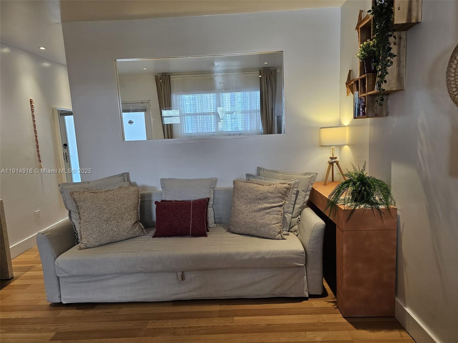 751 Collins Avenue, Unit 2 Miami Beach, FL 33139 - Photo 11 of 25 a living room with furniture and a fireplace