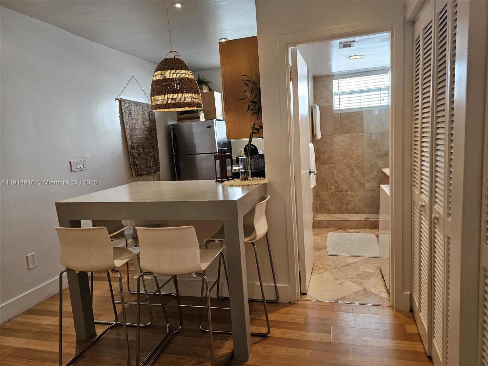 751 Collins Avenue, Unit 2 Miami Beach, FL 33139 - Photo 13 of 25 a view of a hallway that has a table and chairs