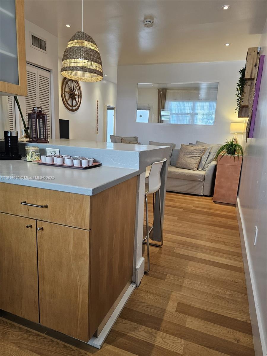 751 Collins Avenue, Unit 2 Miami Beach, FL 33139 - Photo 15 of 25 a living room with furniture a clock and wooden floor