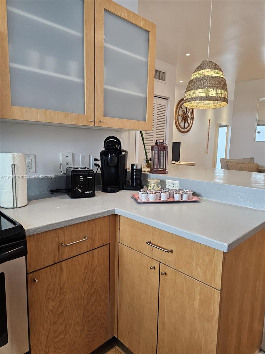 751 Collins Avenue, Unit 2 Miami Beach, FL 33139 - Photo 17 of 25 a kitchen with a sink and cabinets