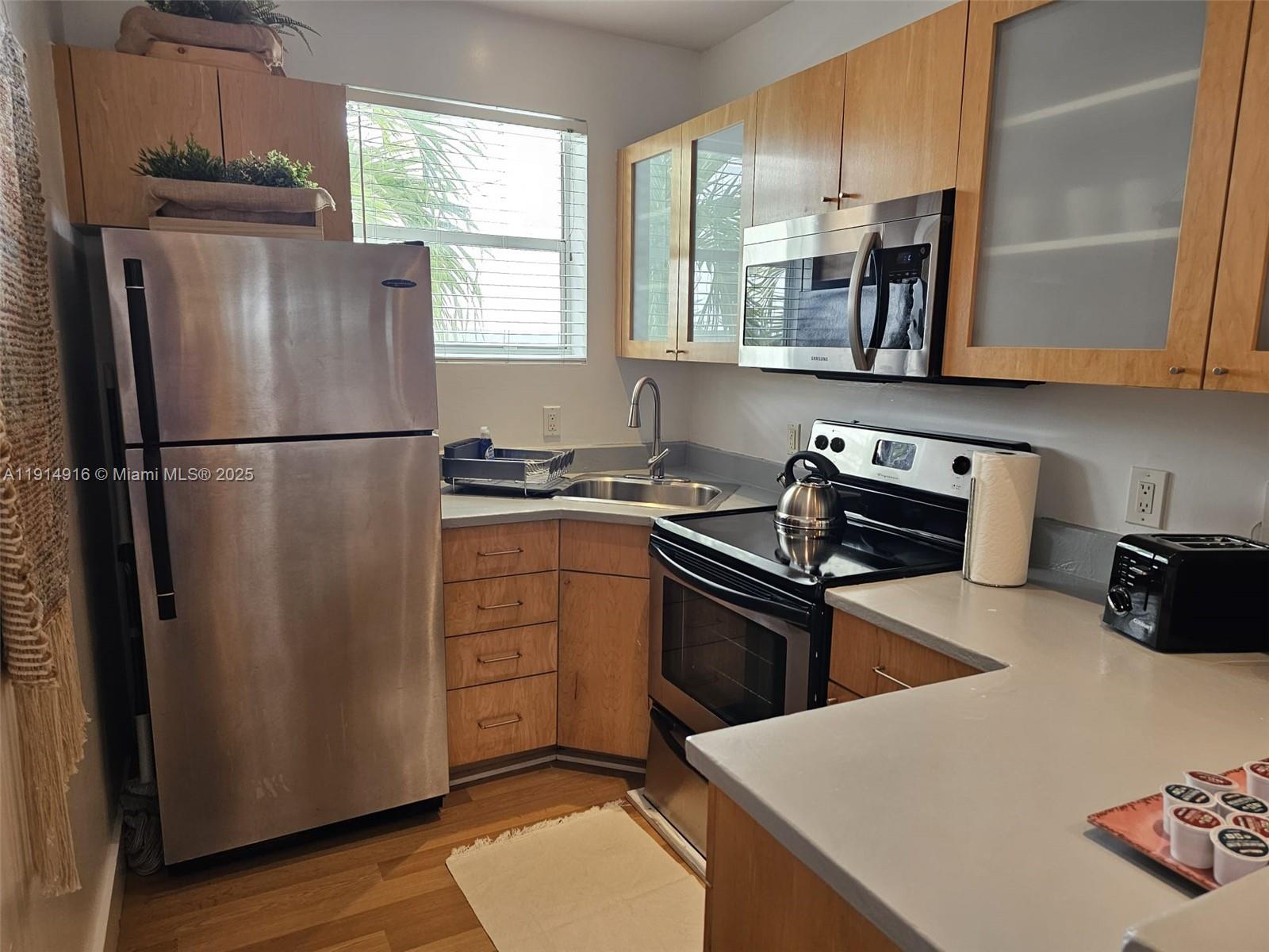 751 Collins Avenue, Unit 2 Miami Beach, FL 33139 - Photo 19 of 25 a kitchen with stainless steel appliances a refrigerator sink and microwave