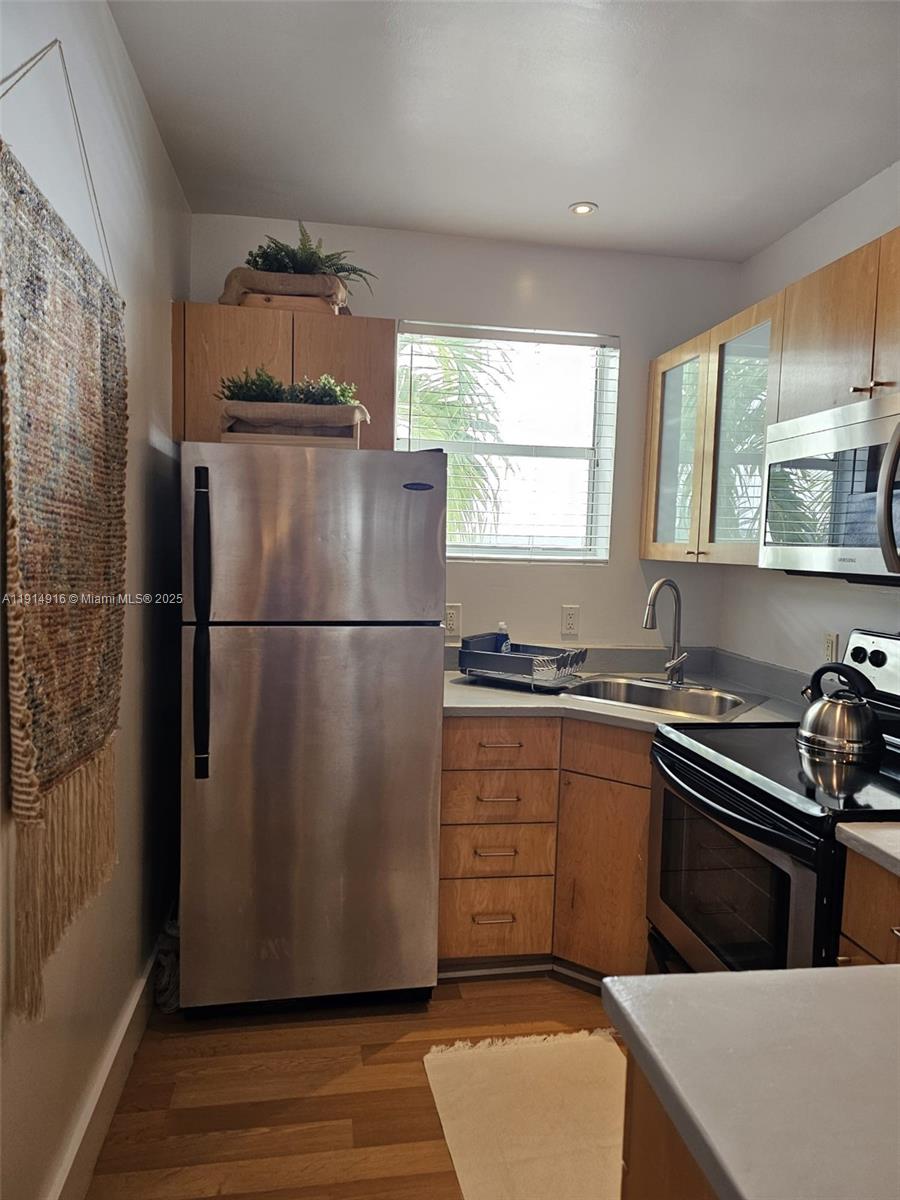 751 Collins Avenue, Unit 2 Miami Beach, FL 33139 - Photo 20 of 25 a kitchen with a refrigerator and a sink