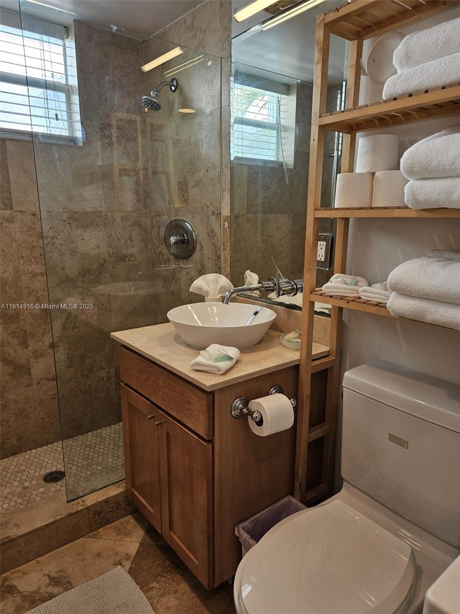 751 Collins Avenue, Unit 2 Miami Beach, FL 33139 - Photo 23 of 25 a bathroom with a sink toilet and shower