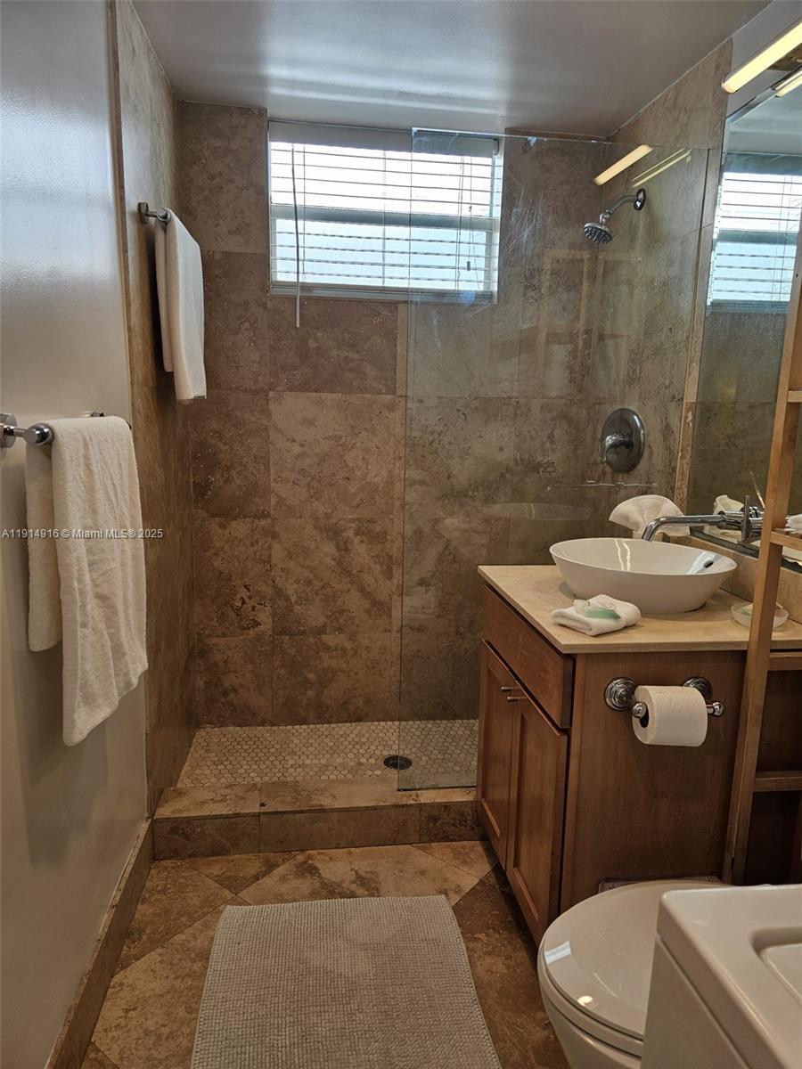 751 Collins Avenue, Unit 2 Miami Beach, FL 33139 - Photo 24 of 25 a bathroom with a sink a toilet and shower