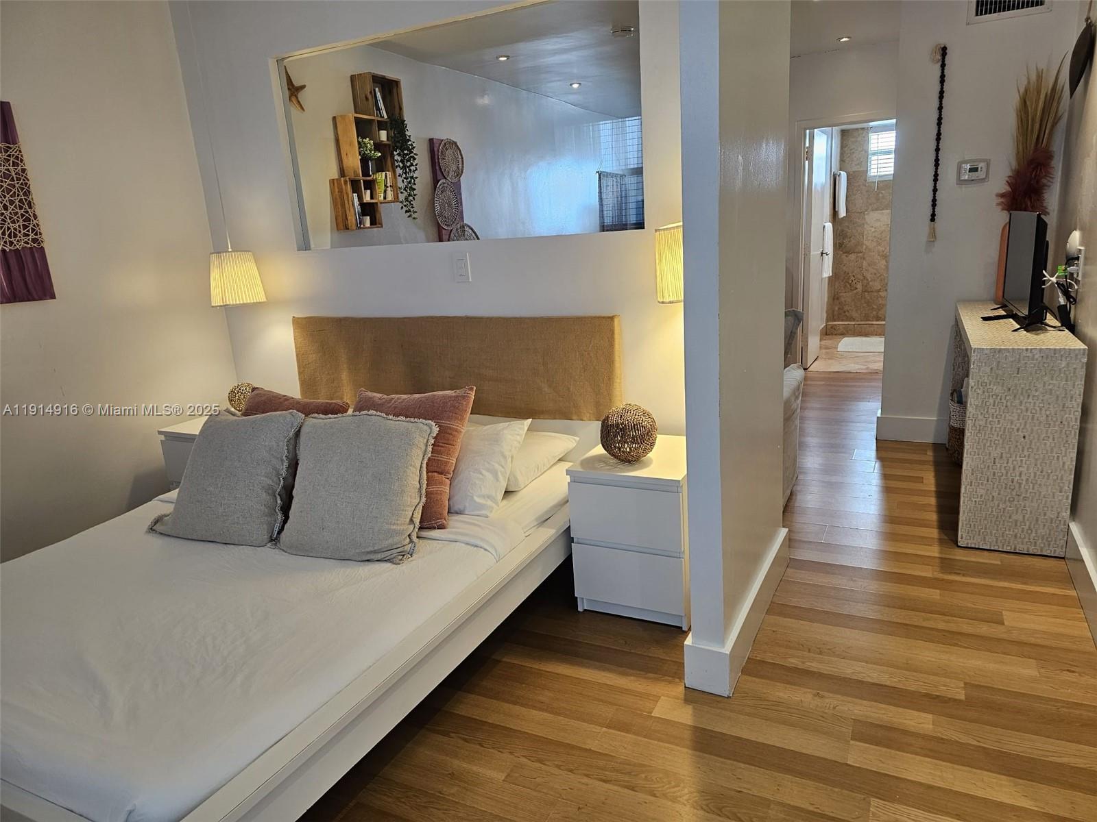 751 Collins Avenue, Unit 2 Miami Beach, FL 33139 - Photo 4 of 25 a bed room with a bed and a television