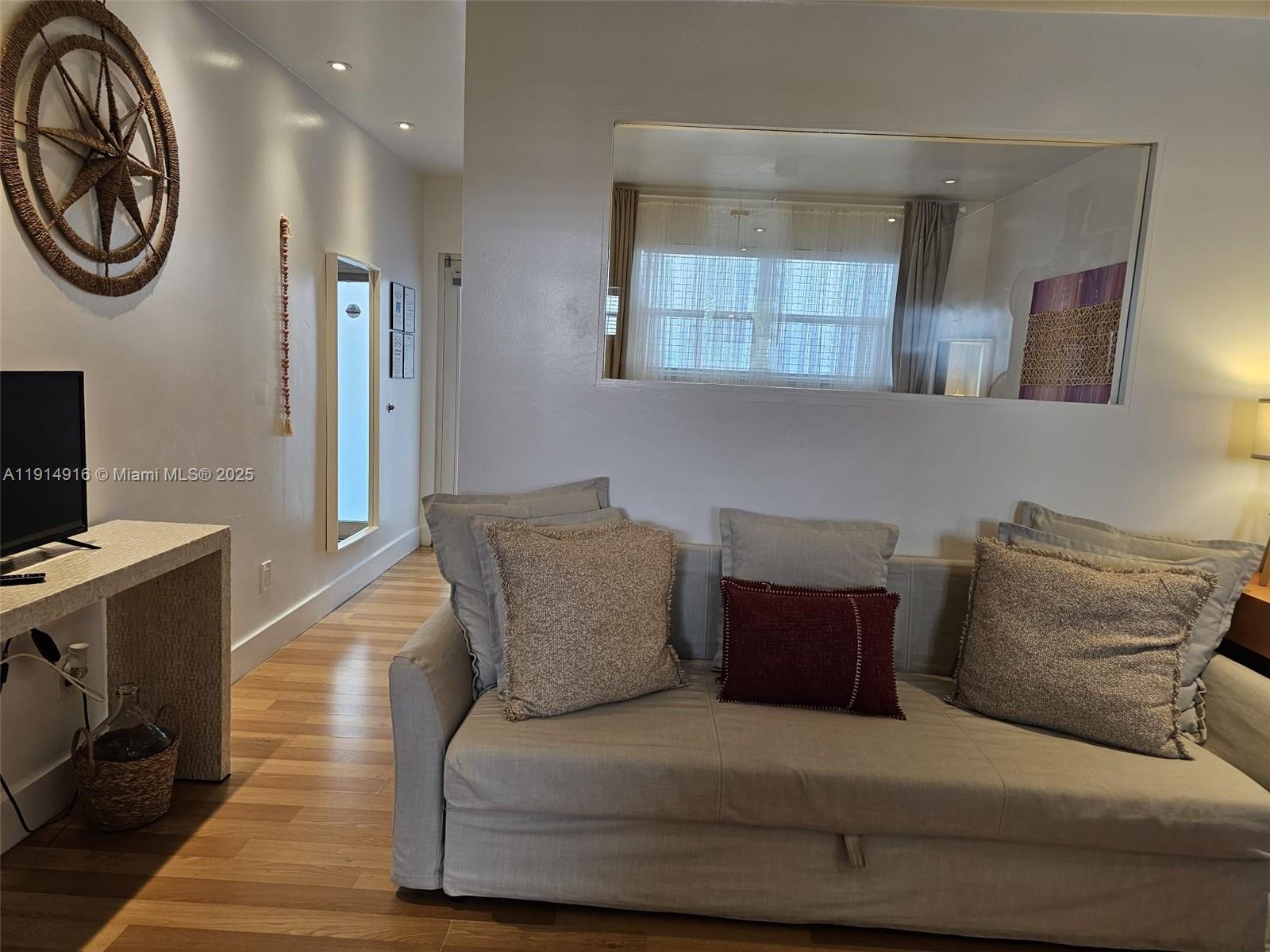 751 Collins Avenue, Unit 2 Miami Beach, FL 33139 - Photo 6 of 25 a bedroom with a bed and a chandelier