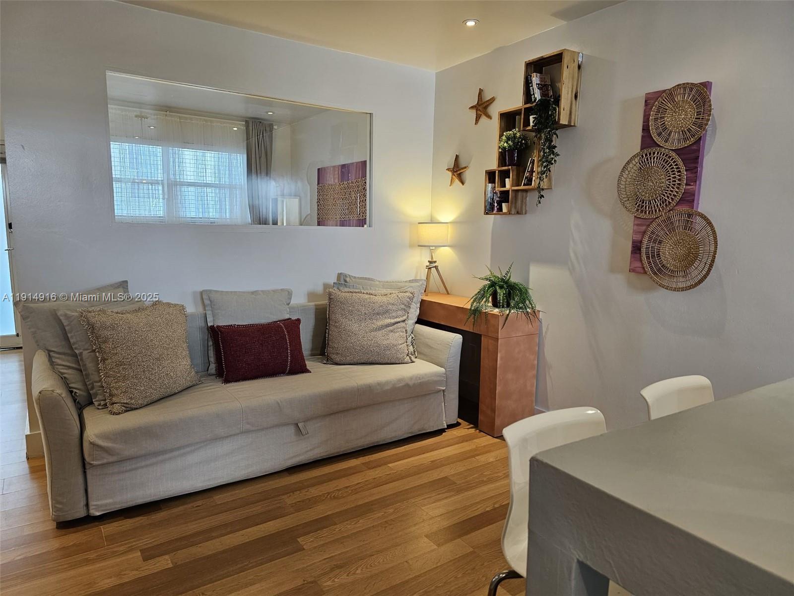 751 Collins Avenue, Unit 2 Miami Beach, FL 33139 - Photo 7 of 25 a living room with furniture and a wooden floor