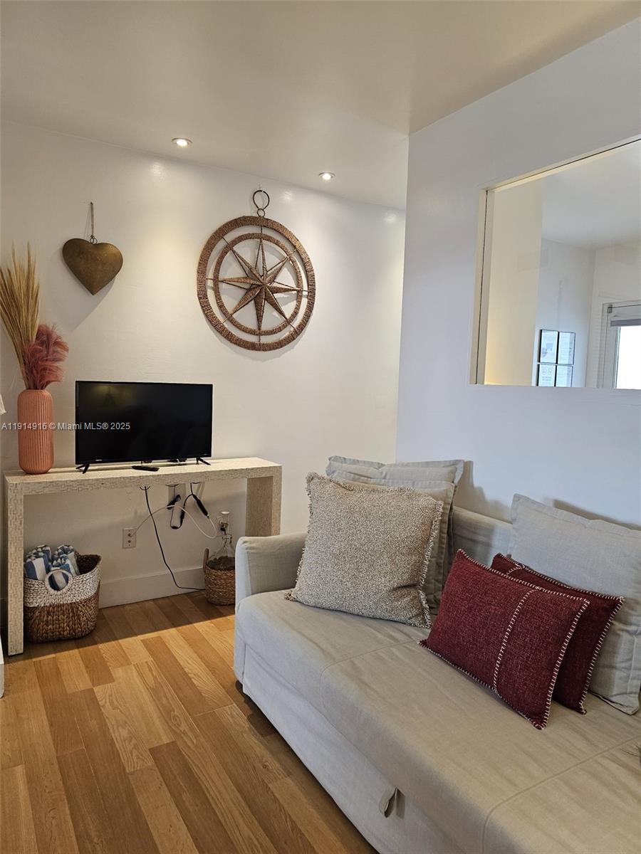 751 Collins Avenue, Unit 2 Miami Beach, FL 33139 - Photo 8 of 25 a living room with furniture and a flat screen tv