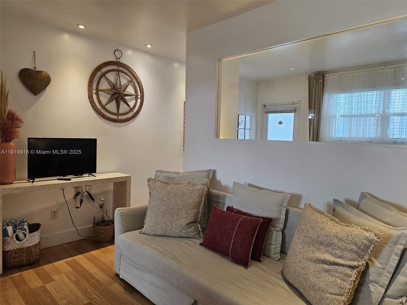 751 Collins Avenue, Unit 2 Miami Beach, FL 33139 - Photo 9 of 25 a view of a livingroom with furniture and a tv