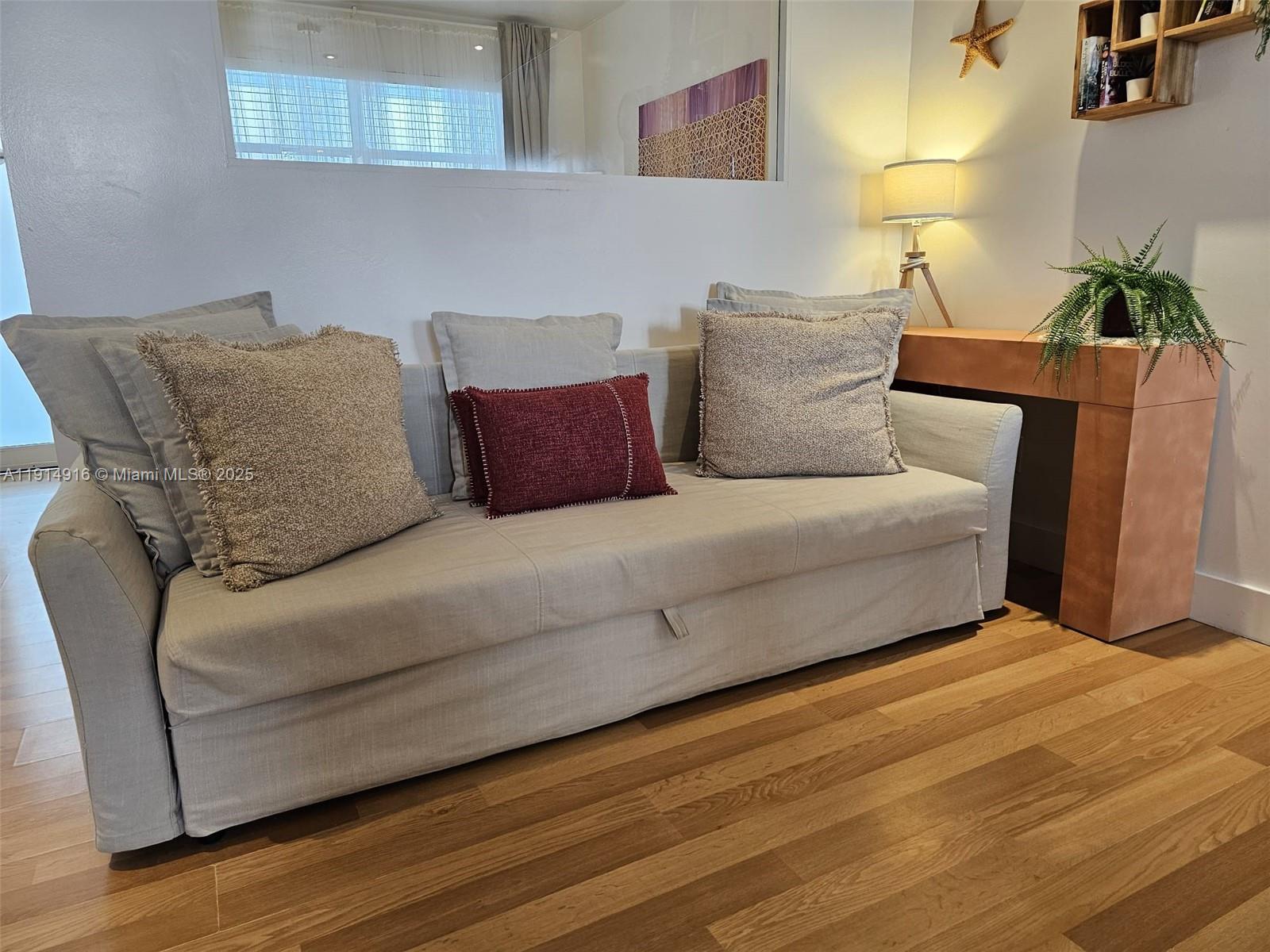 751 Collins Avenue, Unit 2 Miami Beach, FL 33139 - Photo 10 of 25 a bedroom with a bed and a potted plant on table