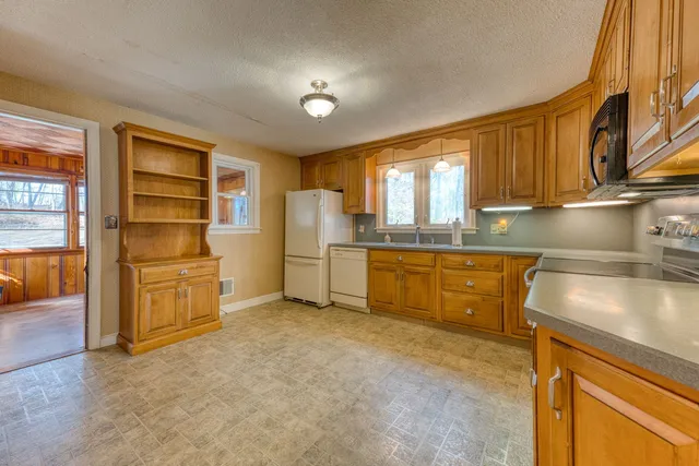 a kitchen with refrigerator and cabinets