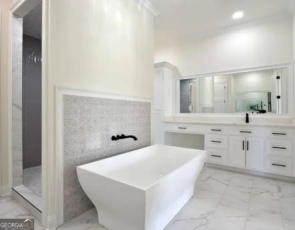 a large white bathroom with a sink a mirror and a bathtub