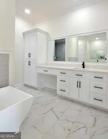 a spacious bathroom with a granite countertop sink a mirror and a bathtub