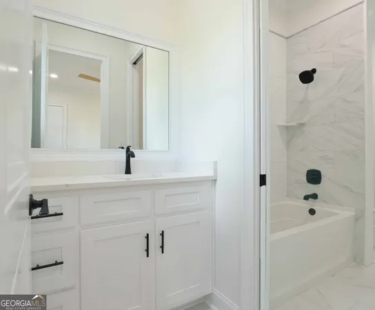 a bathroom with a bathtub and a sink
